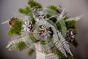 Close-up of a pine cone on a Christmas bokeh background, selective focus, blurred background, texture