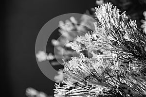 A close-up of pine needles on an artificial Christmas tree