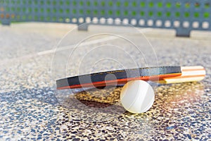 Close-up of a Ping-pong paddle with a table-tennis white ball