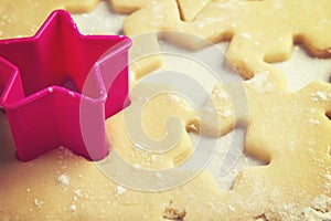 Close up of pink cookie cutter in dough