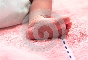 Close up pink foot of newborn baby in postpartum care unit in hospital when she sleeping with her mother, so cute.