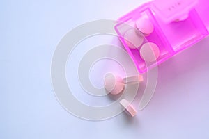 Close up of pink pills on pill contianer