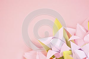 Close up pink and purple Origami paper tulips on pink background. Copy space. Happy International Women's Day, March 8