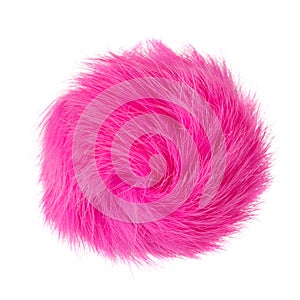 Close up of pink rabbit fur pompom isolated on white background