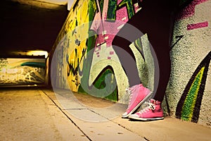 Close up of pink sneakers worn by a teenager.