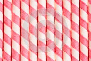 Close up of a Pink striped wafer stick rolls textured background