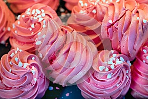 Close-up of a pink sweet meringues with spiral shape