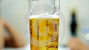 close-up, a pint glass with cold, light beer. water droplets on the glass, the walls of the beer glass.