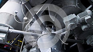 Close-up of pipelines and destillation tanks of an oil-refinery plant. Close up of steel pipes at modern beer factory