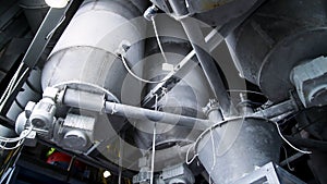 Close-up of pipelines and destillation tanks of an oil-refinery plant. Close up of steel pipes at modern beer factory