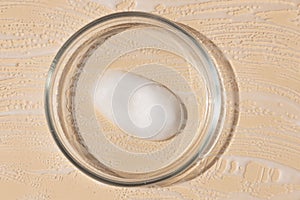 close-up of pipette and petri dish with facial serum gel