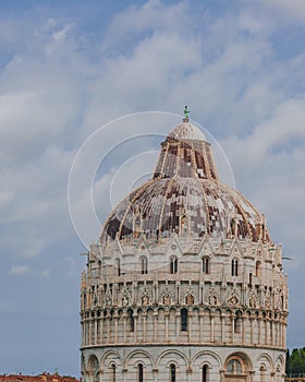 Close-up of the Pisa Baptistry under sky and clouds, in the Cathedral Square of Pisa, Italy