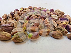 Close up of pistachio place on the floor with simple background photo