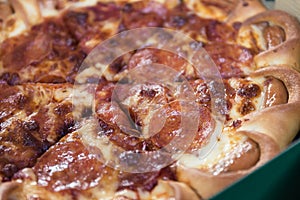 Close up of pizza in a fast delivery box.