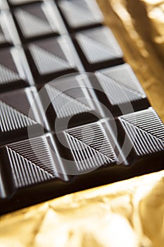 Close Up Of Plain Chocolate Bar On Foil Wrapper