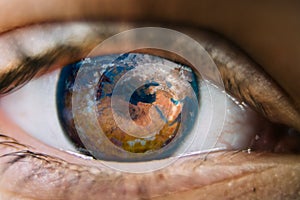 Close-up of planet earth in the eye of a child. View of a child on the environmental world.