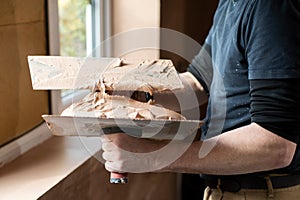 Close Up Of Plasterer Plastering Room Of House