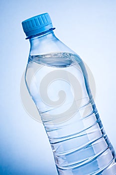 Close-up plastic bottle of drinking water obliquely