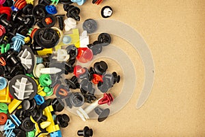Close-up of plastic colored clips for car.Abstract background. Panel plastic rivets, plastic clips