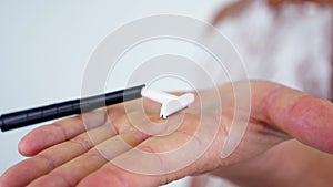 Close up, plastic razor for shaving on male hand, white background and Naked hairy male chest in shaving foam. shaving