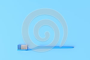 Close-up plastic toothbrush on the blue background with copy space