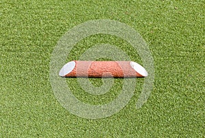 Close-up plastic wooden tee off area or tee box in green golf co