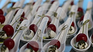 Close up of a plate of classic Italian caprese salad on a skewer. Event catering.