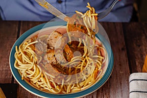 close-up of a plate of meatballs with spaghetti with cutlery