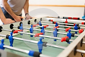 Close up of players playing table soccer