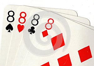 Close up of playing cards showing four eights.