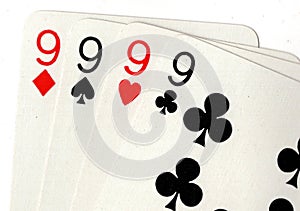 Close up of playing cards showing four nines. photo