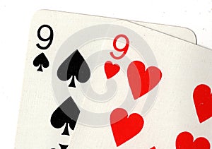 Close up of playing cards showing a pair of nines.