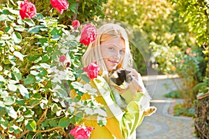 Close-up pleasant friendly-looking joyful attractive european woman blonde haircolor smiling holding a cat happily