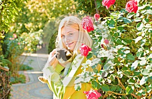 Close-up pleasant friendly-looking joyful attractive european woman blonde haircolor smiling holding a cat happily