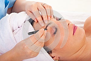 Close up of plucking eyebrows