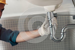 Close up of plumber is repairing faucet at bathroom. Good quality plumbing company service