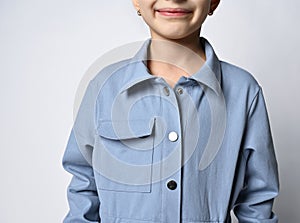 Close-up: a pocket on a denim jacket, overalls, a fragment of a photograph of a girl in a blue jacket with a patch