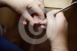 Close-up of a podiatrist chiropodist cleaning woman`s feet in beauty salon. Process of pedicure