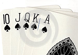 Close up of a poker hand of playing cards showing a royal flush.