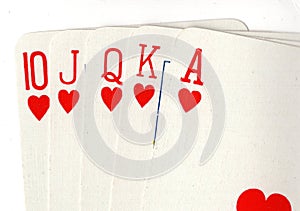 Close up of a poker hand of playing cards showing a royal flush.