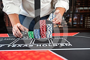 close up of poker player hold poker chips. Blackjack in a casino