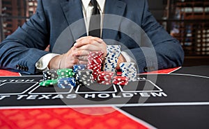 close up of poker player hold poker chips. Blackjack in a casino