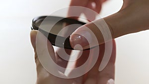 Close up of polarizing lens filter in girls hands isolated on white background. Concept. Woman turning into the both