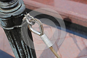 Close up pole with metal restraining rope. Barrier, enclosed VIP area, protected entrance, private event.