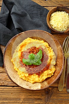 Close up Polenta with ragu` bologenese in ceramic bowl