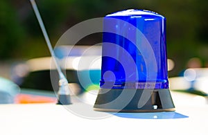 Close up of police blue light atop of a patrol car.