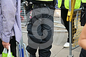 Close up of police duty belt showing handcuffs and CS gas spray