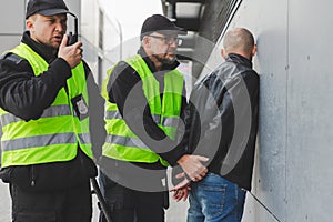 policemen speaking on the walkie-talkie during intervention photo