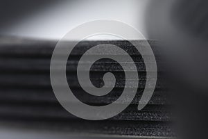 Close-up of a poly V-belt of a generator on a gray background in shallow depth of field. Background for rubber products