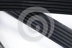 Close-up of a poly V-belt of a generator on a gray background in shallow depth of field. Background for rubber products